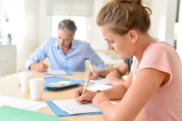 College Students Filling In Registration Forms